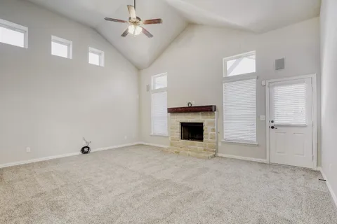 a view of an empty room with a fireplace