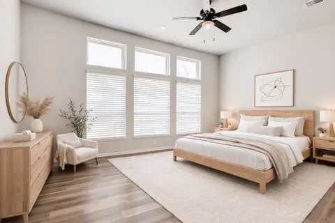 a spacious bedroom with a bed a couch and large window