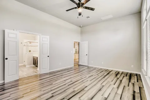 a view of an empty room and wooden floor