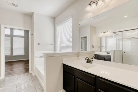 a bathroom with a sink double vanity and a mirror