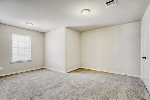 an empty room with a empty space and windows