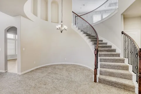 a view of staircase with white walls and stairs