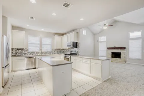 a kitchen with cabinets and white appliances
