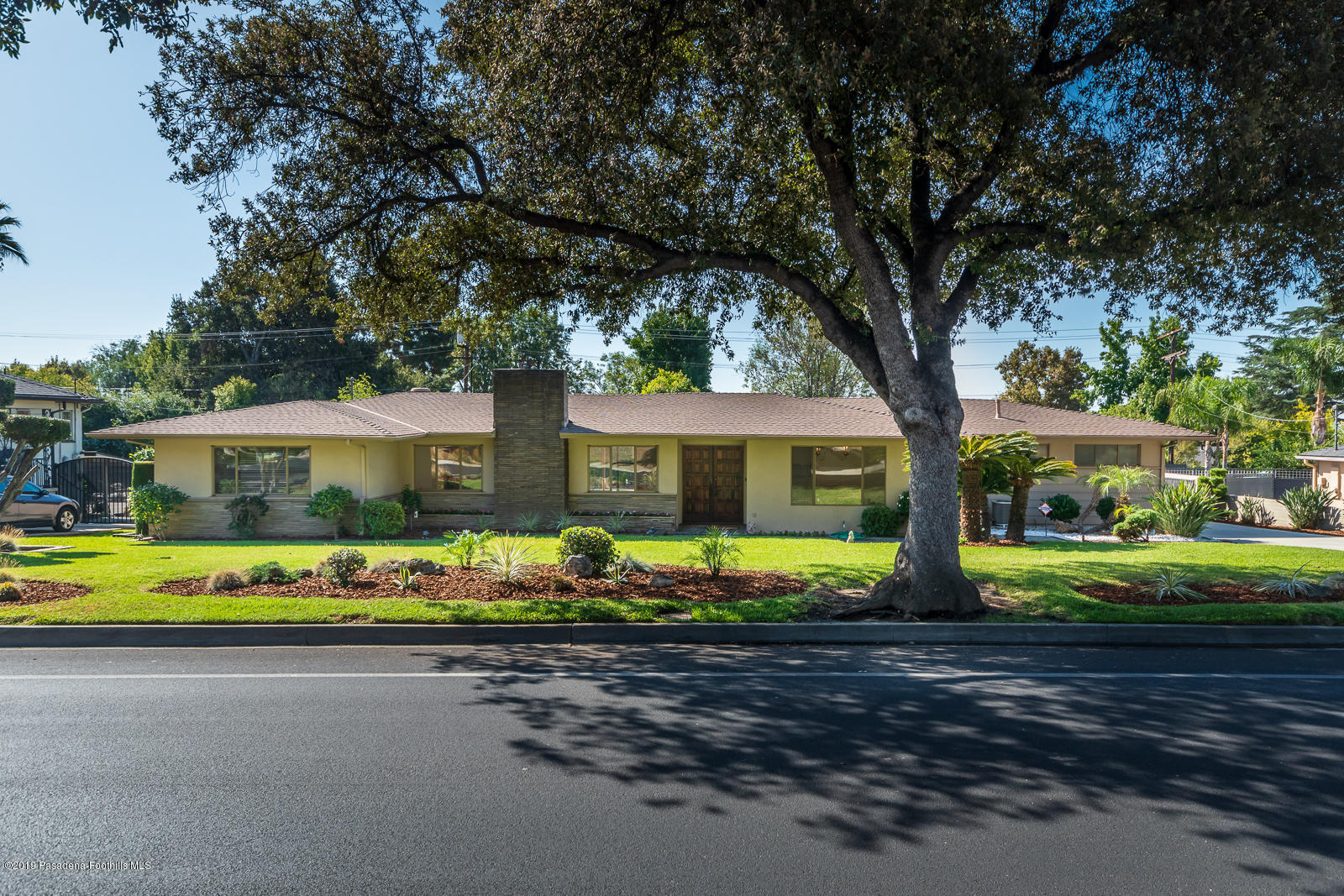 3810 Greenhill Road Pasadena, CA 91107 - Photo 2 of 29 a front view of a house with a big yard and potted plants
