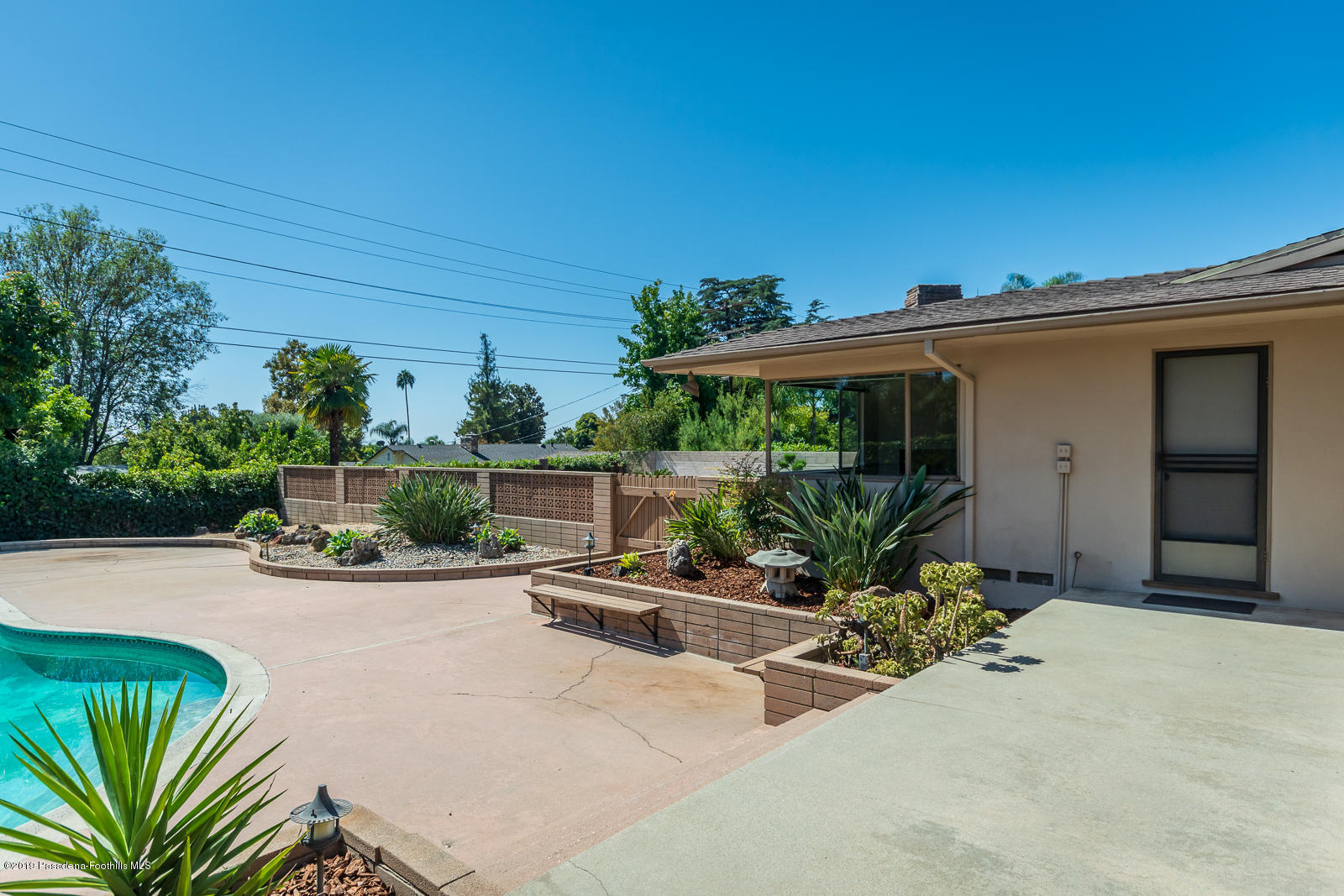 3810 Greenhill Road Pasadena, CA 91107 - Photo 24 of 29 a view of a patio with table and chairs potted plants with wooden fence