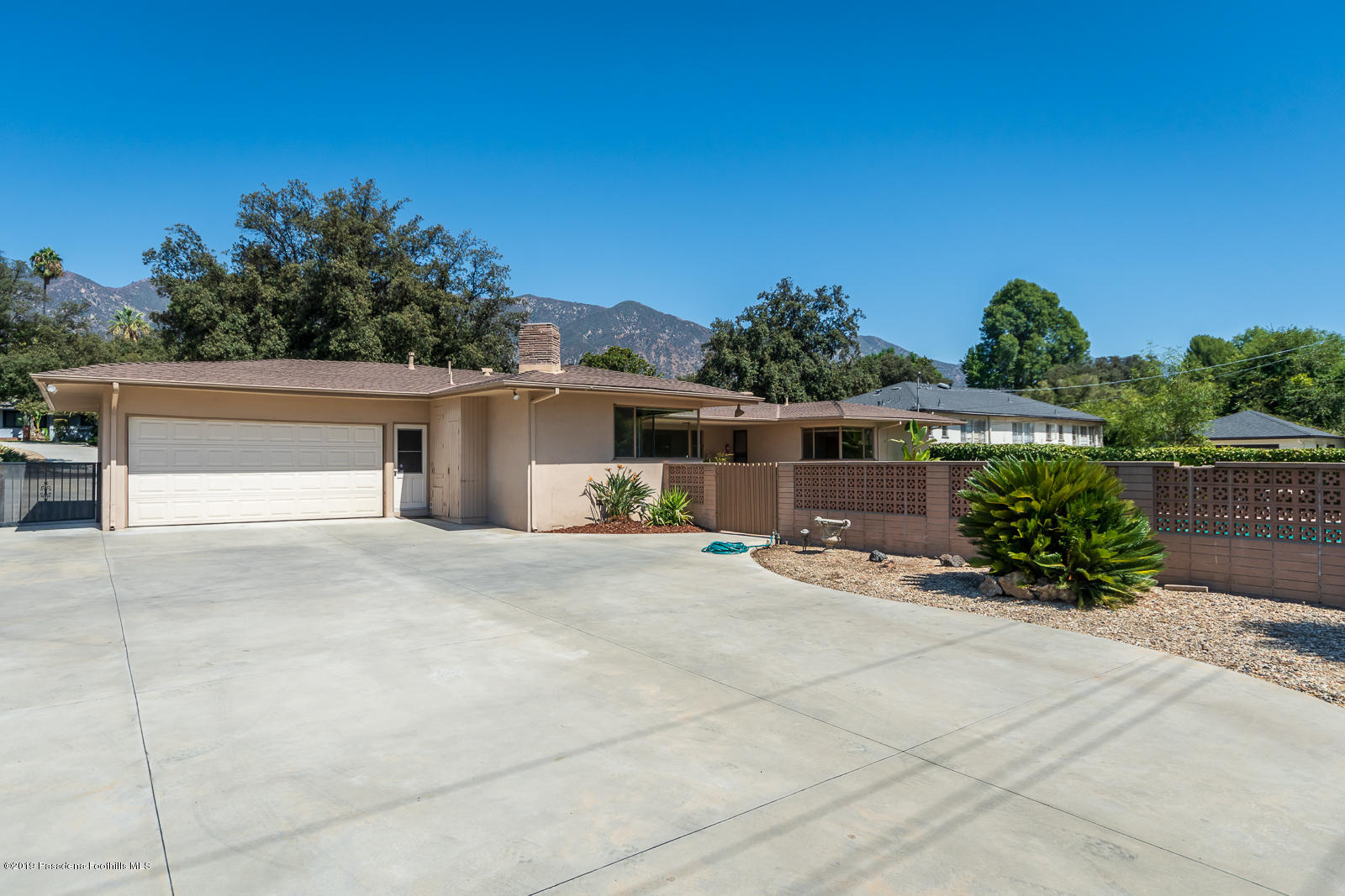 3810 Greenhill Road Pasadena, CA 91107 - Photo 29 of 29 front view of house with potted plants in front of it
