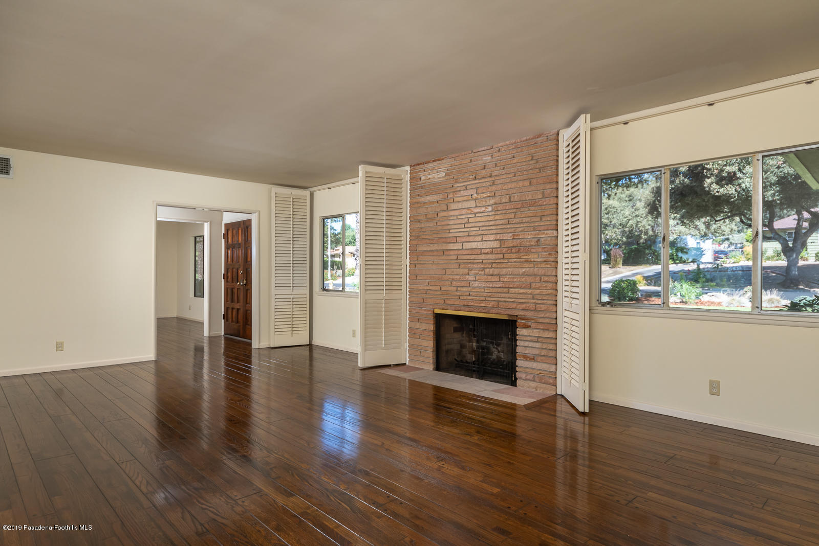 3810 Greenhill Road Pasadena, CA 91107 - Photo 5 of 29 a view of an empty room with wooden floor and a window