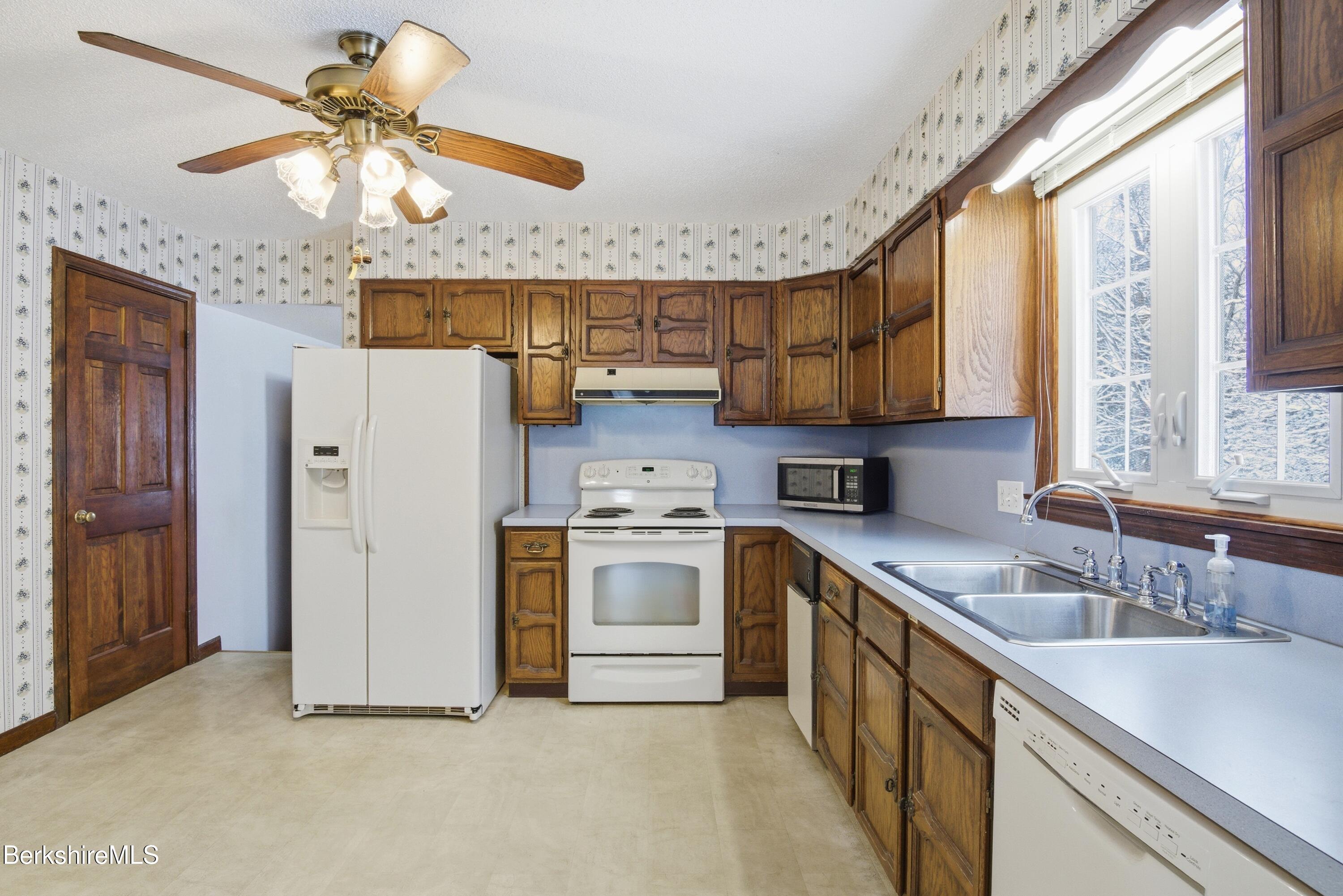 121 Kittredge Road Pittsfield, MA 01201 - Photo 14 of 38 a kitchen with stainless steel appliances granite countertop a sink a stove and refrigerator