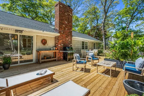 a view of a patio with couches table and chairs and potted plants