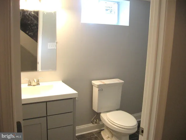 a white toilet sitting next to a bathroom sink