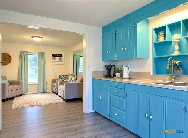 a spacious bedroom with a bed and wooden floors