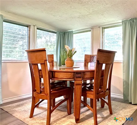 a view of a dining room with furniture window and outside view