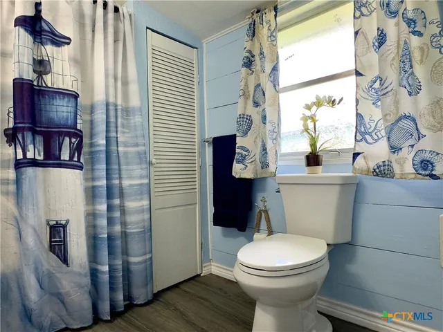 a white toilet sitting next to a bathroom sink