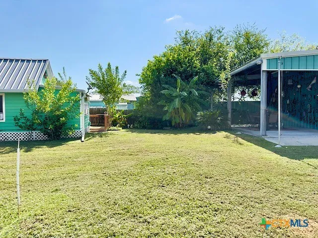 a backyard of a house with table and chairs
