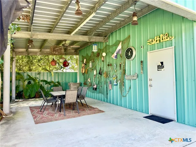 a view of a chairs and table in patio