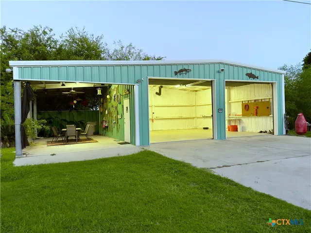 a view of a patio with table and chairs a barbeque with wooden fence