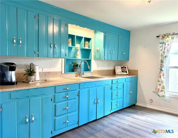 a kitchen with cabinets a sink and a dishwasher