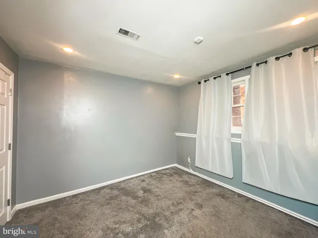 a view of an empty room with a fireplace