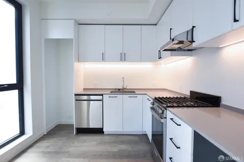 a kitchen with stainless steel appliances granite countertop a sink and a stove