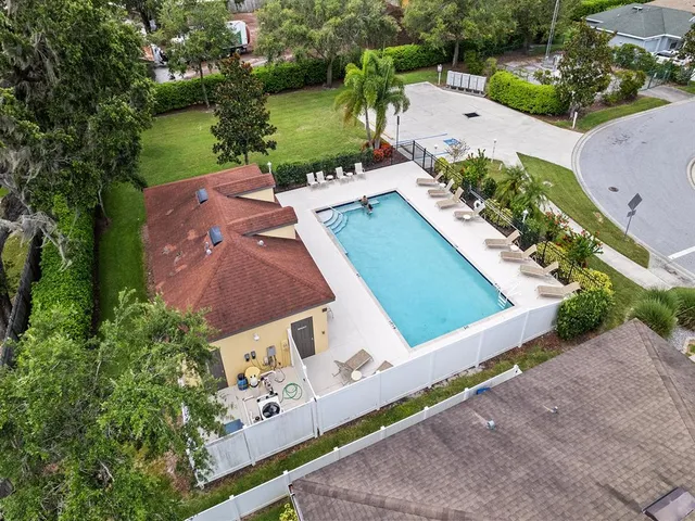 a dining room with furniture water view and a floor to ceiling window