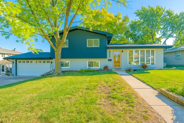 a view of a house with pool and a yard