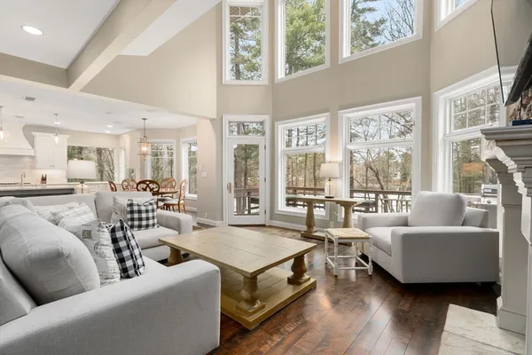 a living room with furniture wooden floor and a large window