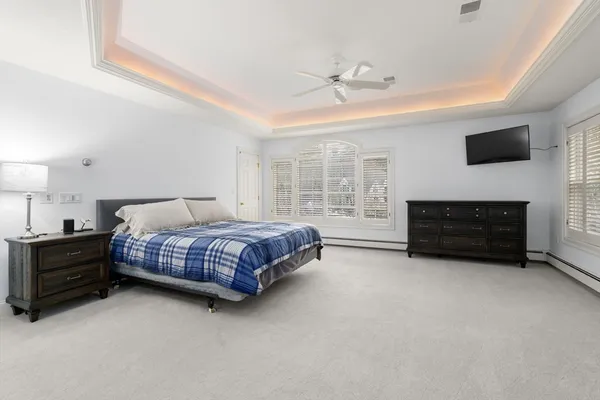 a bedroom with a bed and a television