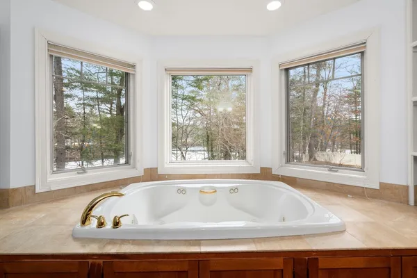 a view of a bath tub sitting in a bathroom next to a window