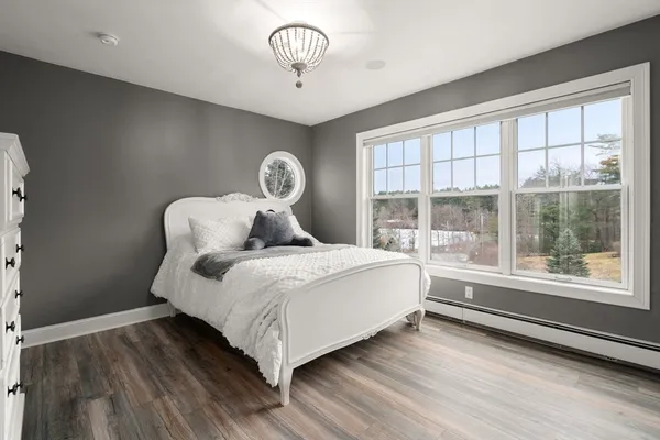 a bedroom with a bed and a large window