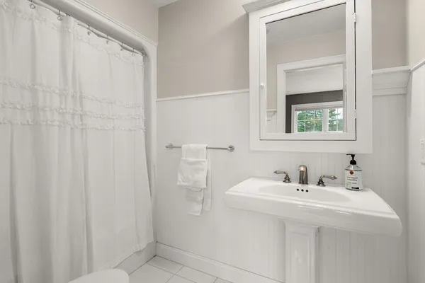 a bathroom with a sink a mirror and a shower