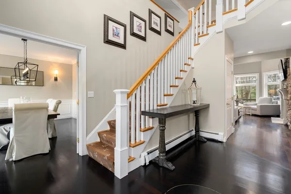 a view of entryway livingroom and hall with wooden floor