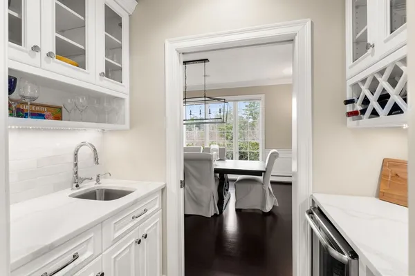 a kitchen with a sink cabinets and wooden floor
