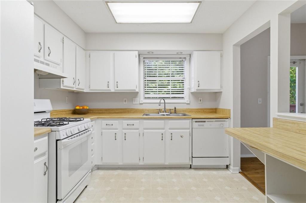 809 Wedgewood Way Atlanta, GA 30350 - Photo 11 of 27 a kitchen with granite countertop cabinets stainless steel appliances and a sink