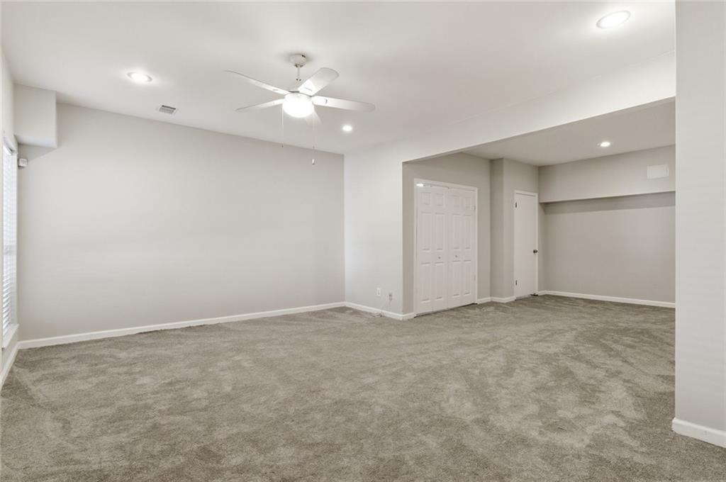 809 Wedgewood Way Atlanta, GA 30350 - Photo 21 of 27 an empty room with a ceiling fan and closet area