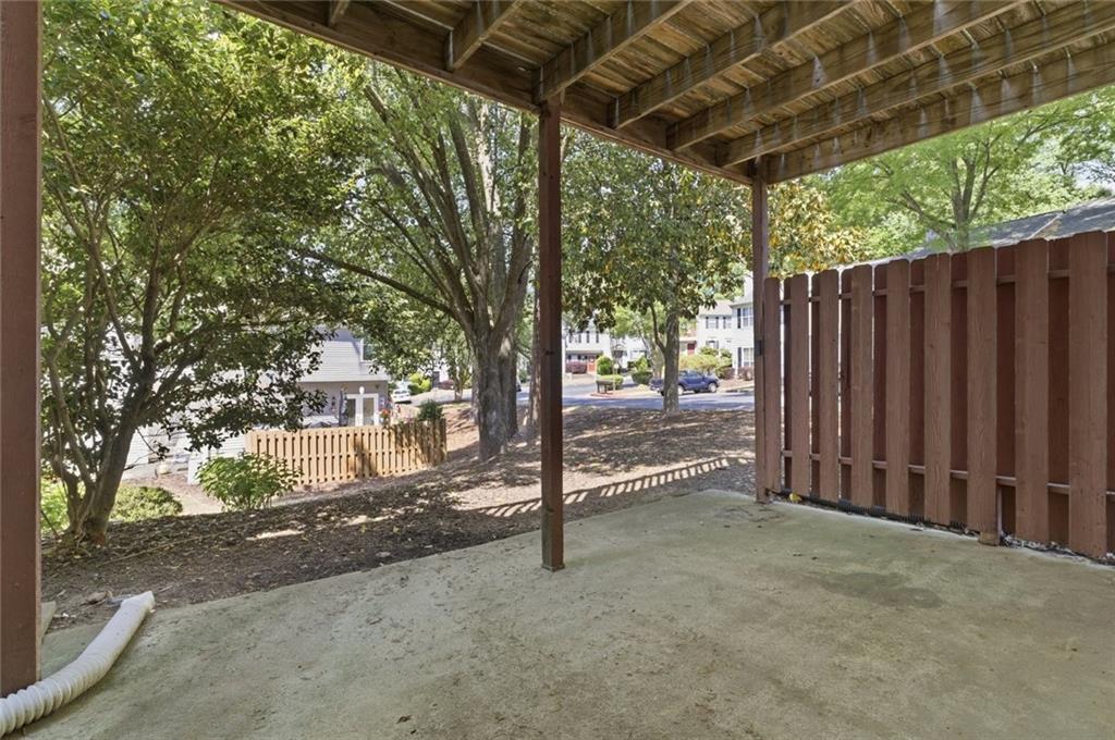809 Wedgewood Way Atlanta, GA 30350 - Photo 25 of 27 a view of a backyard with wooden fence and large trees