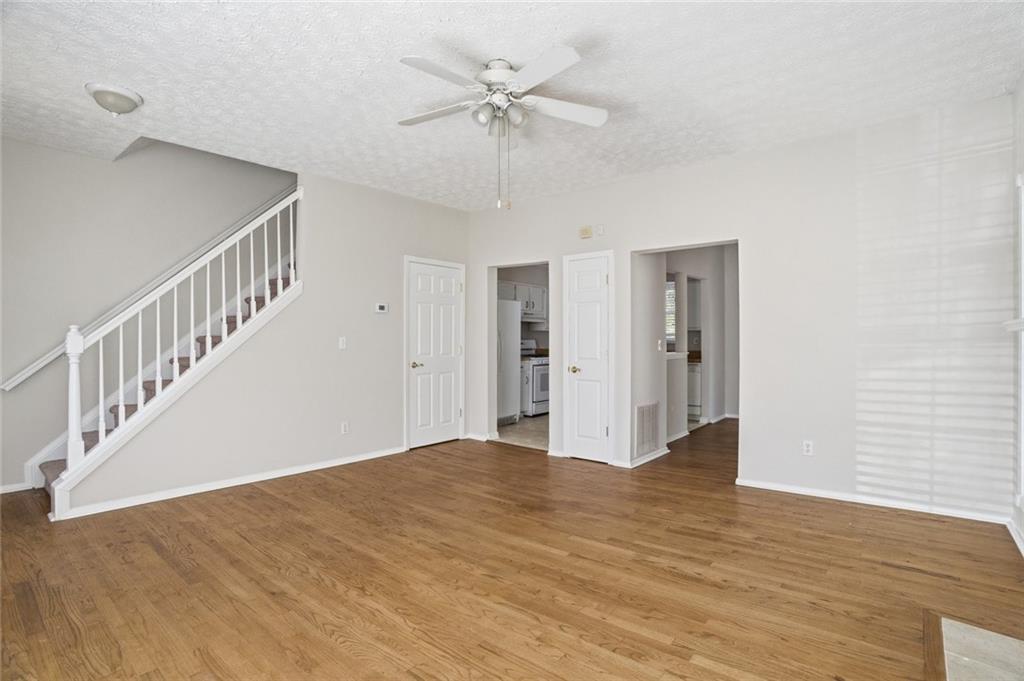 809 Wedgewood Way Atlanta, GA 30350 - Photo 7 of 27 a view of an empty room with a window and a chandelier fan