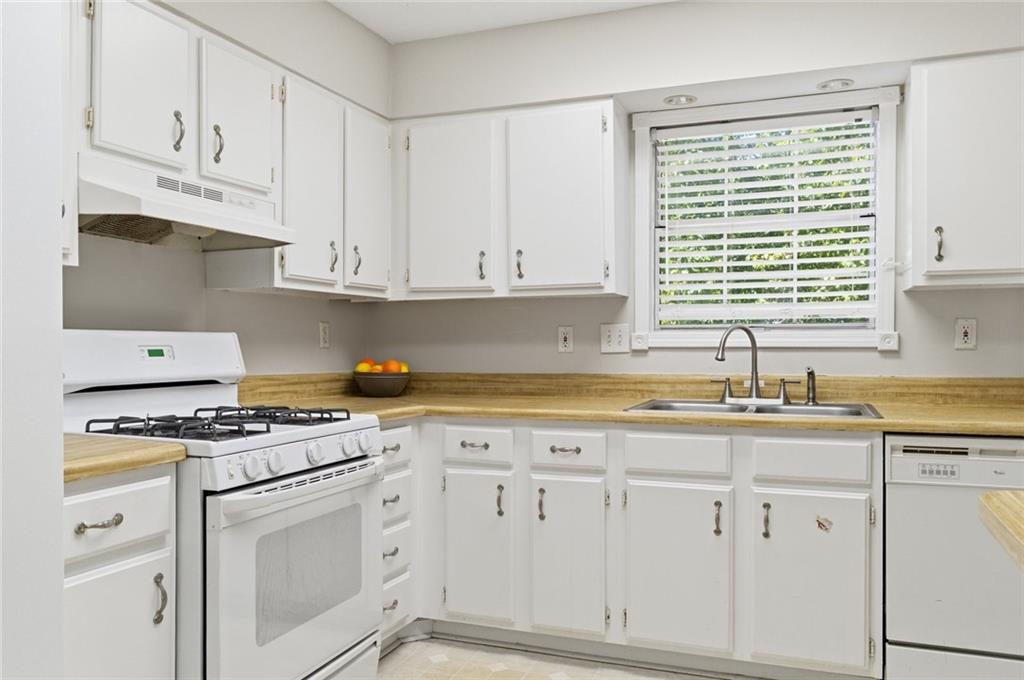 809 Wedgewood Way Atlanta, GA 30350 - Photo 10 of 27 a kitchen with granite countertop white cabinets and white appliances
