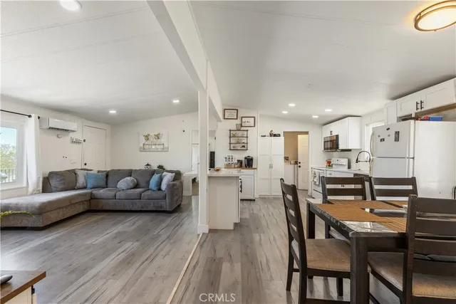 a living room with furniture and kitchen view