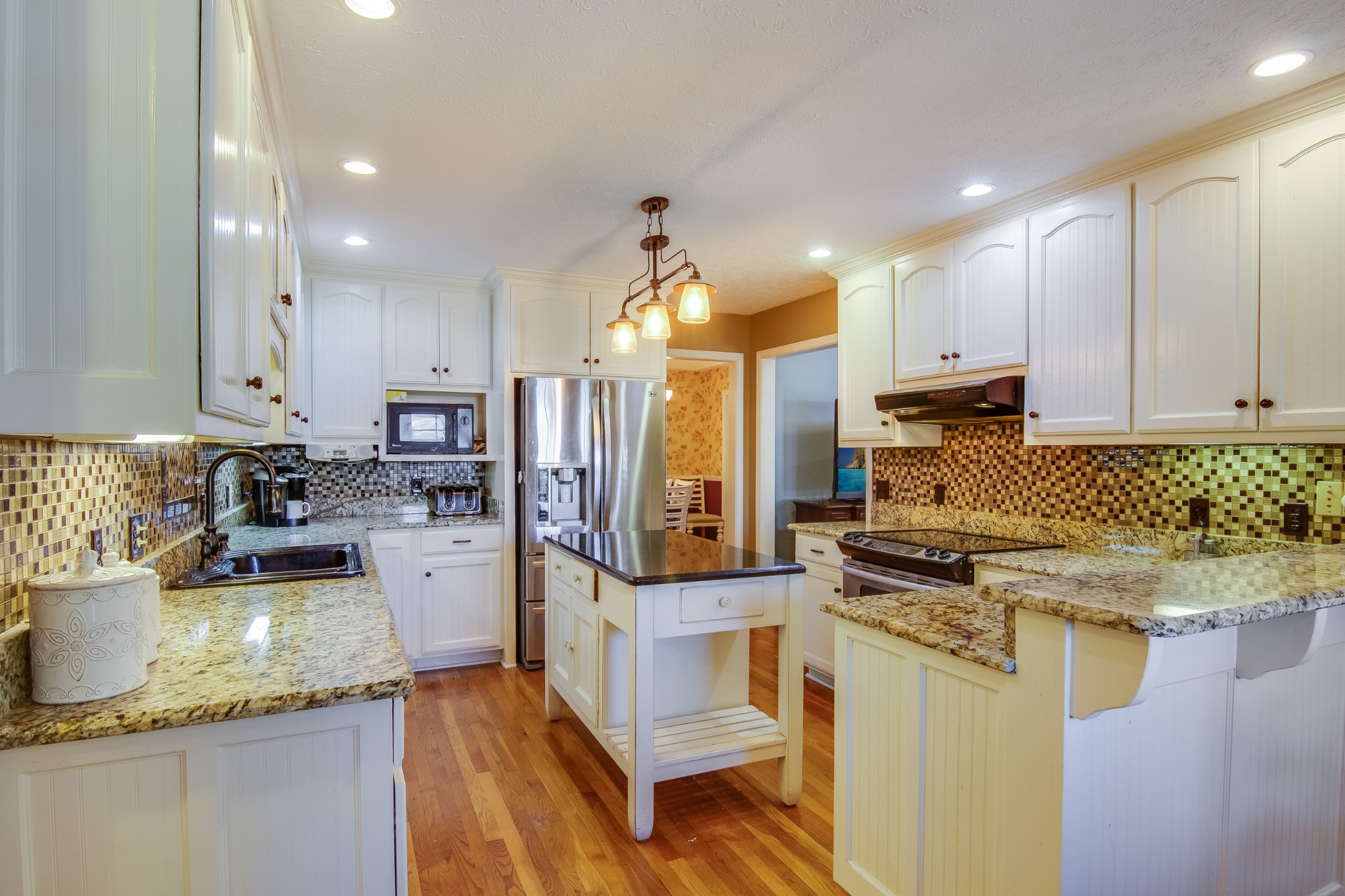 2963 Cole Ridge Road Beechgrove, TN 37018 - Photo 7 of 26 a kitchen with a stove a sink a refrigerator and cabinets