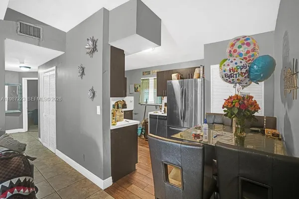 a view of kitchen with stainless steel appliances kitchen island granite countertop a refrigerator and stove