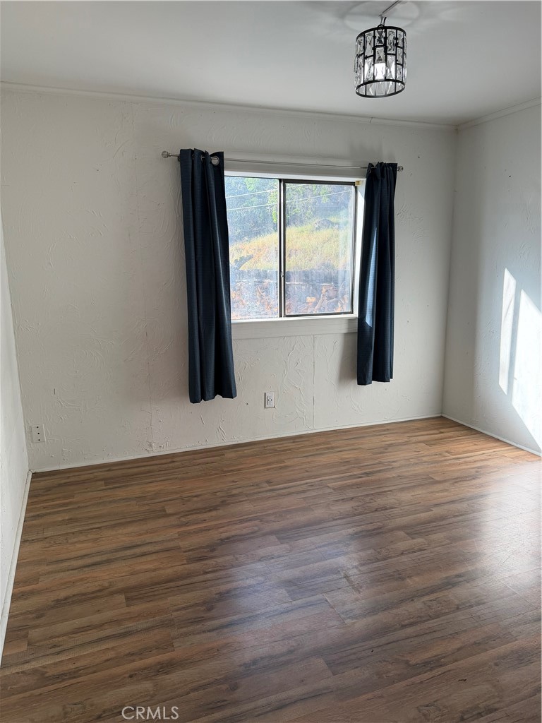 4047 Foothill Drive Lucerne, CA 95458 - Photo 60 of 75 a view of an empty room with wooden floor and a window