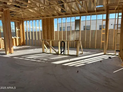 a view of a room with wooden floor and a floor to ceiling window
