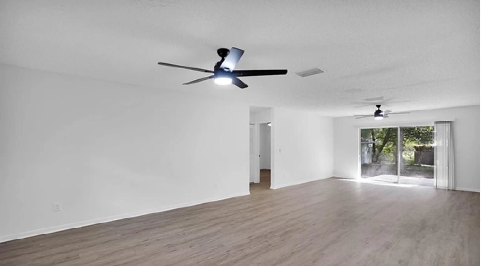 1010 San Remo Road St. Augustine, FL 32086 - Photo 3 of 67 wooden floor in an empty room with a window