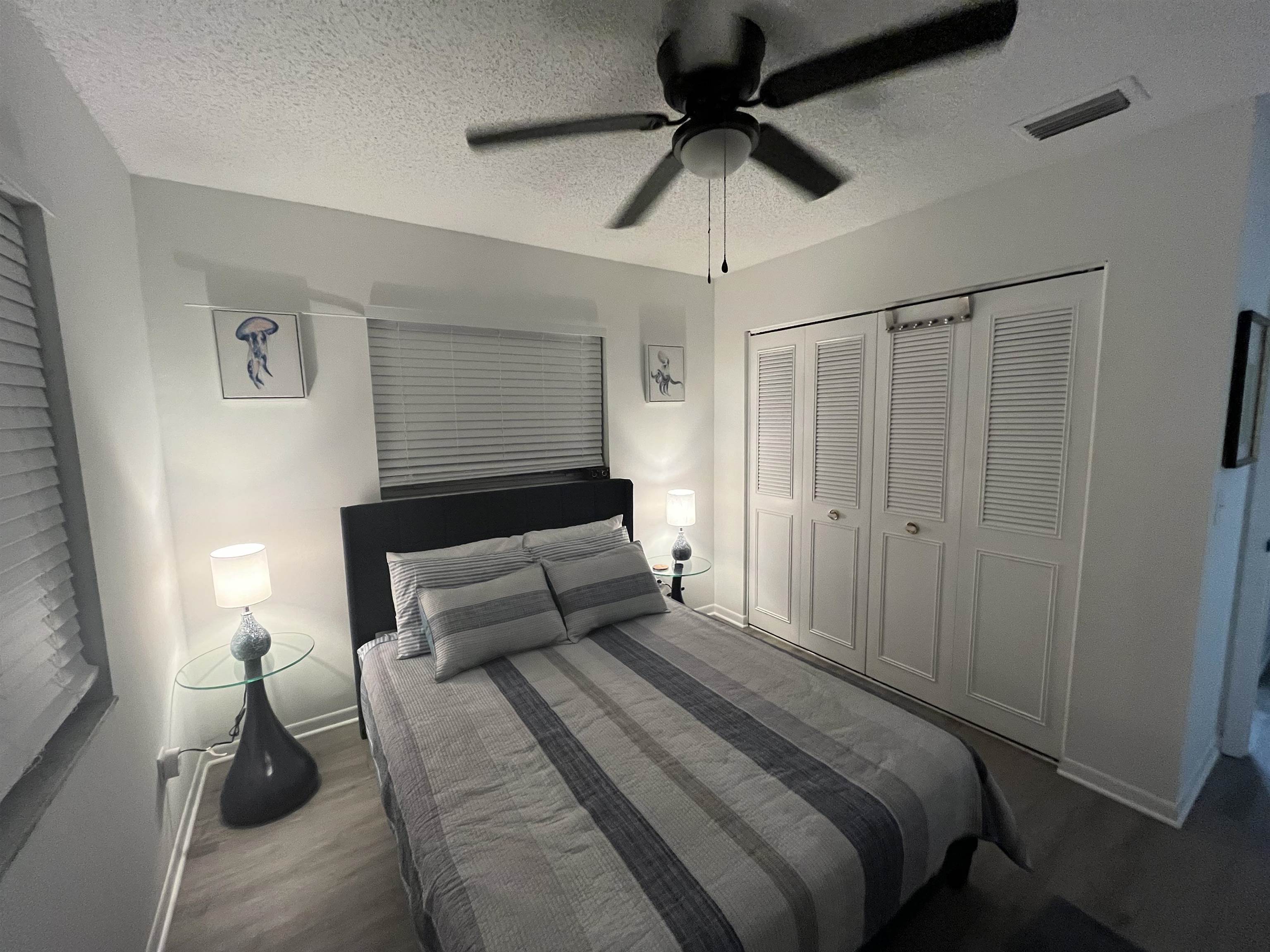 1010 San Remo Road St. Augustine, FL 32086 - Photo 33 of 67 a bedroom with a bed and a chandelier