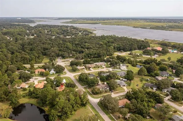 an aerial view of a house with a garden and outdoor space