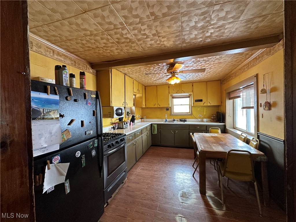 4058 Pardee Road Stow, OH 44224 - Photo 11 of 24 Kitchen featuring an ornate ceiling, appliances with stainless steel finishes, wood finished floors, light countertops, and a sink