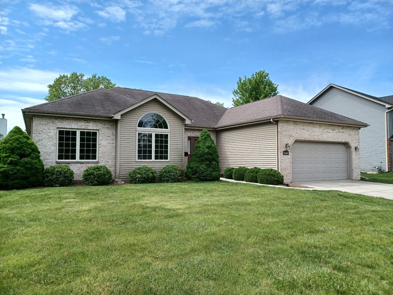 a front view of a house with a yard and garage