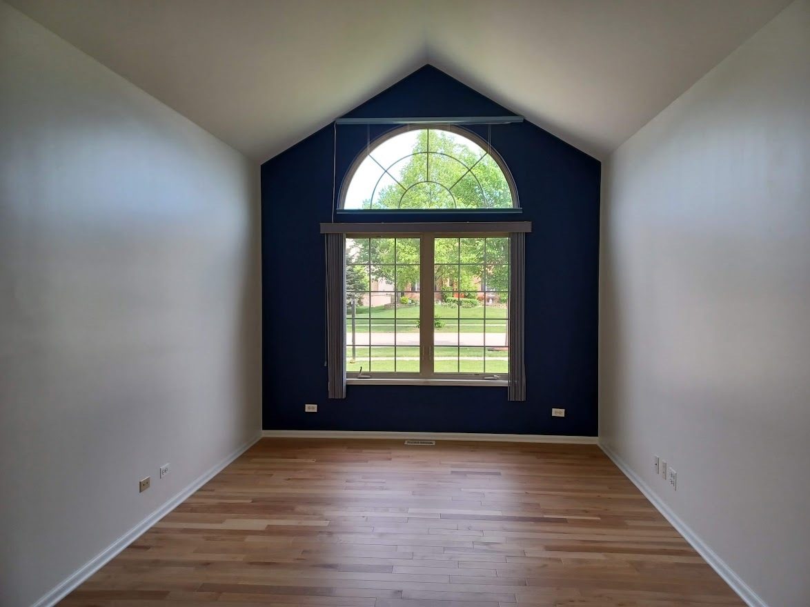 24463 Tufton Street Plainfield, IL 60585 - Photo 11 of 29 an empty room with wooden floor and windows