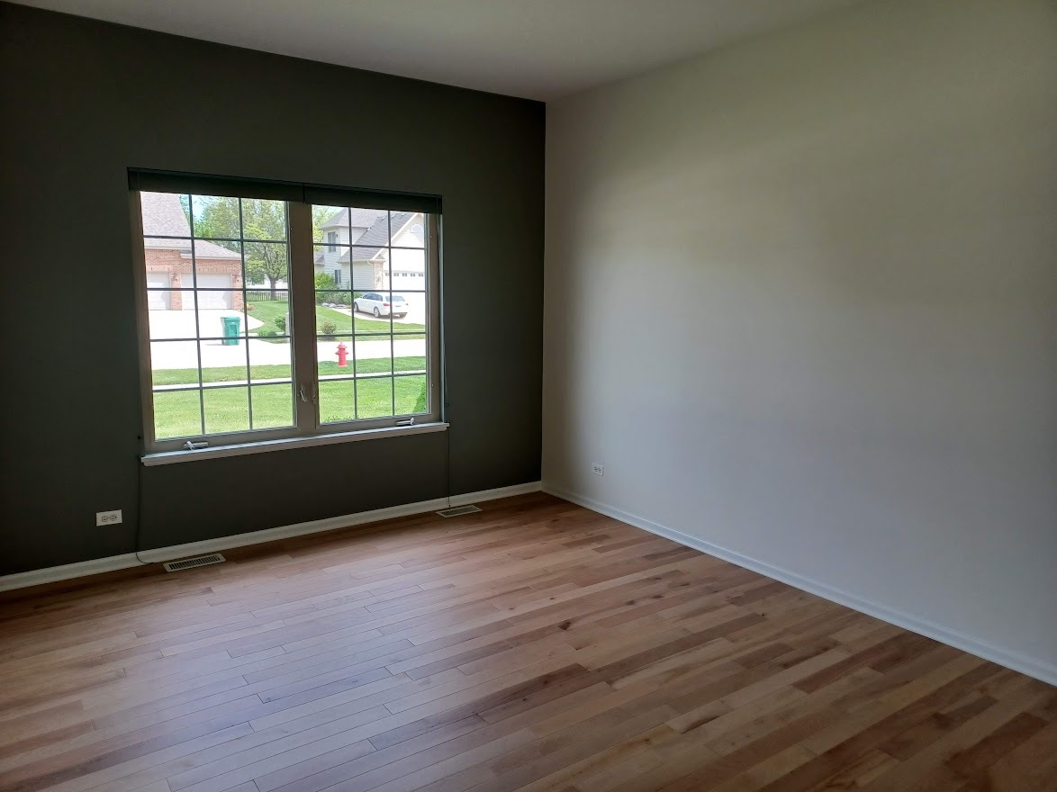 24463 Tufton Street Plainfield, IL 60585 - Photo 12 of 29 an empty room with wooden floor and windows