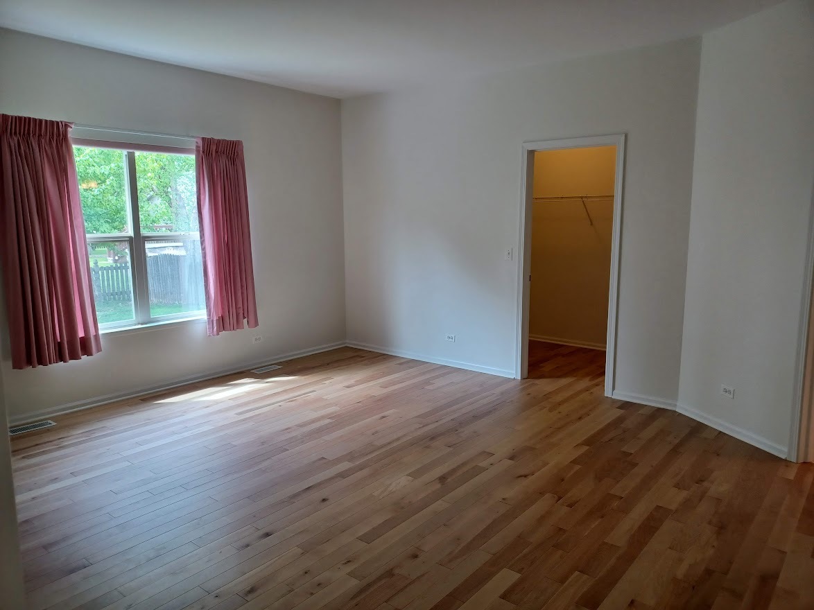 24463 Tufton Street Plainfield, IL 60585 - Photo 15 of 29 a view of an empty room with wooden floor and a window